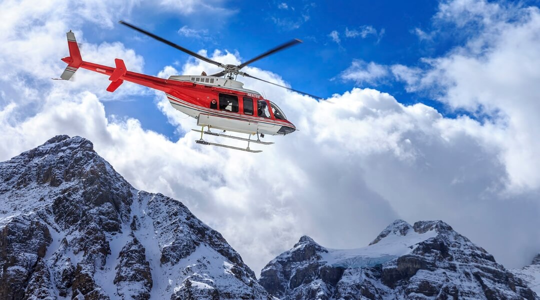 helicopter flying through mountains