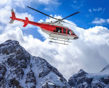 helicopter flying through mountains