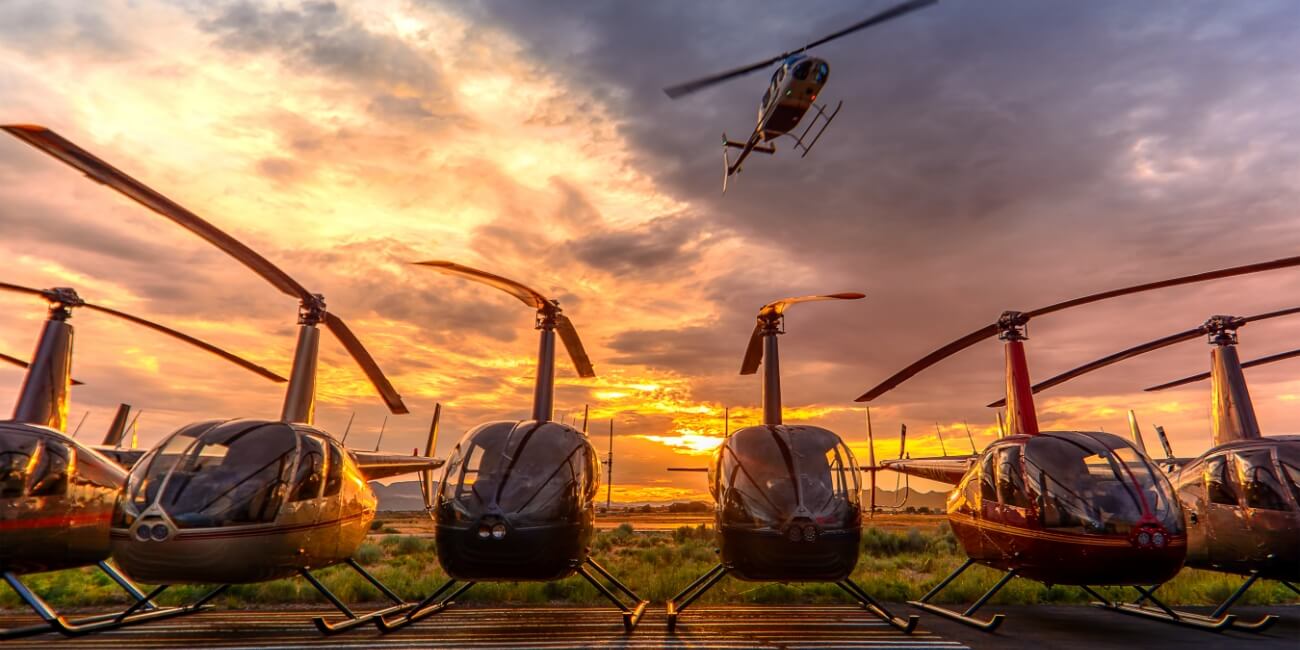 row of helicopters in an airfield