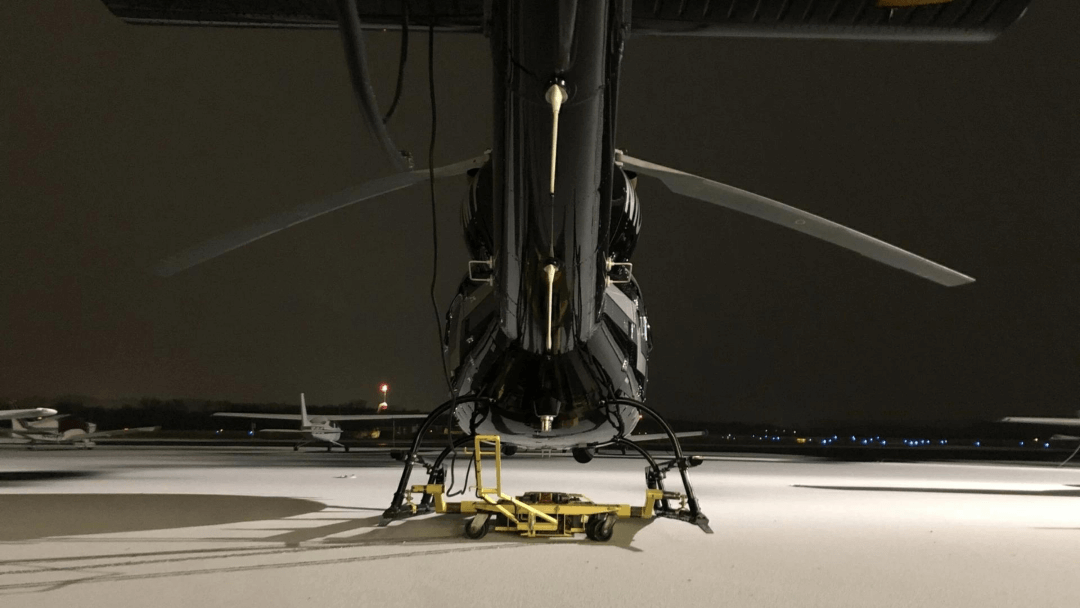 A Chopper Spotter remote ground handling unit moving a large helicopter in the hangar