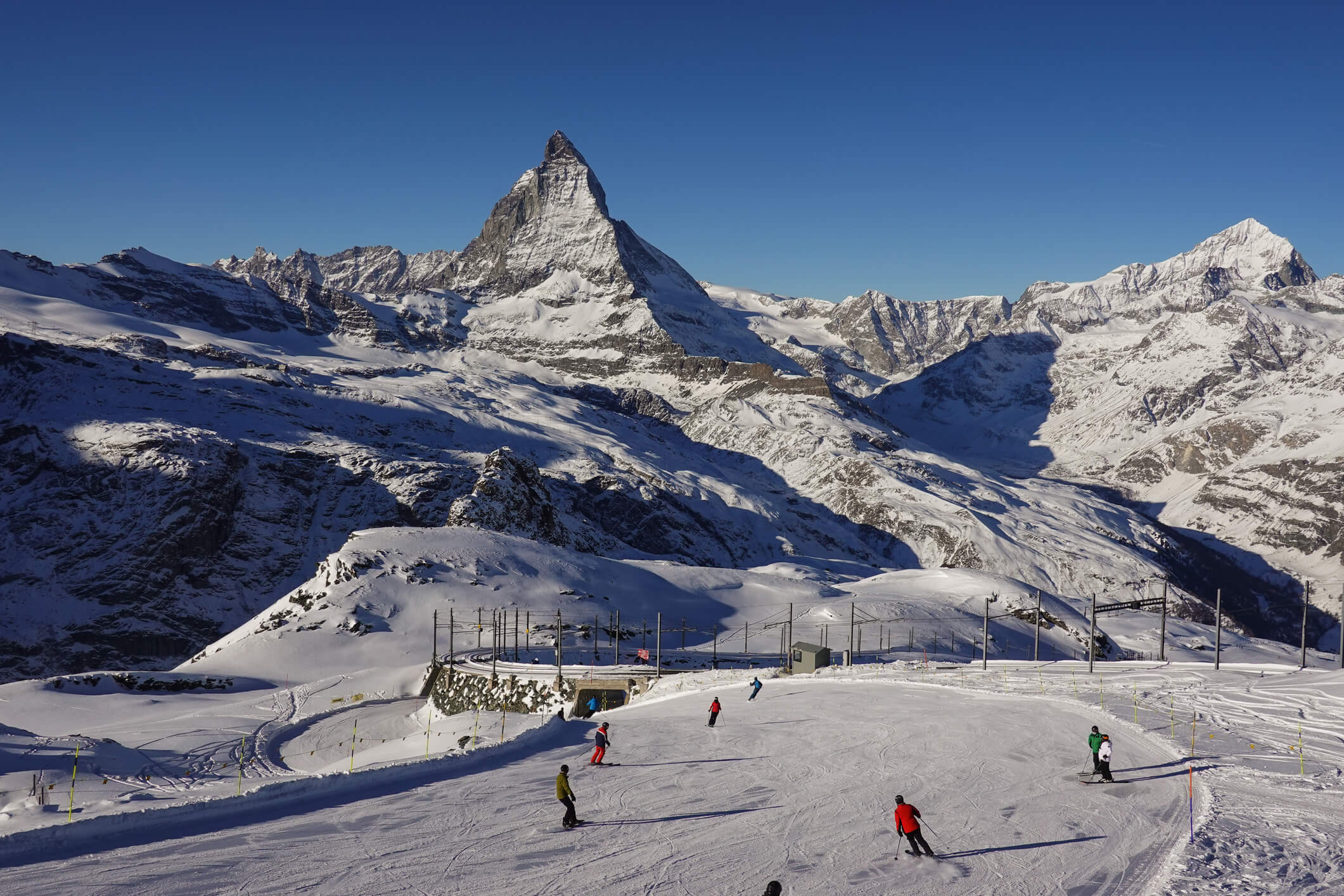 Skiers on the slope of the famous Zermatt ski resort with the iconic Matterhorn peak in the alps in Canton Valais in Switzerland