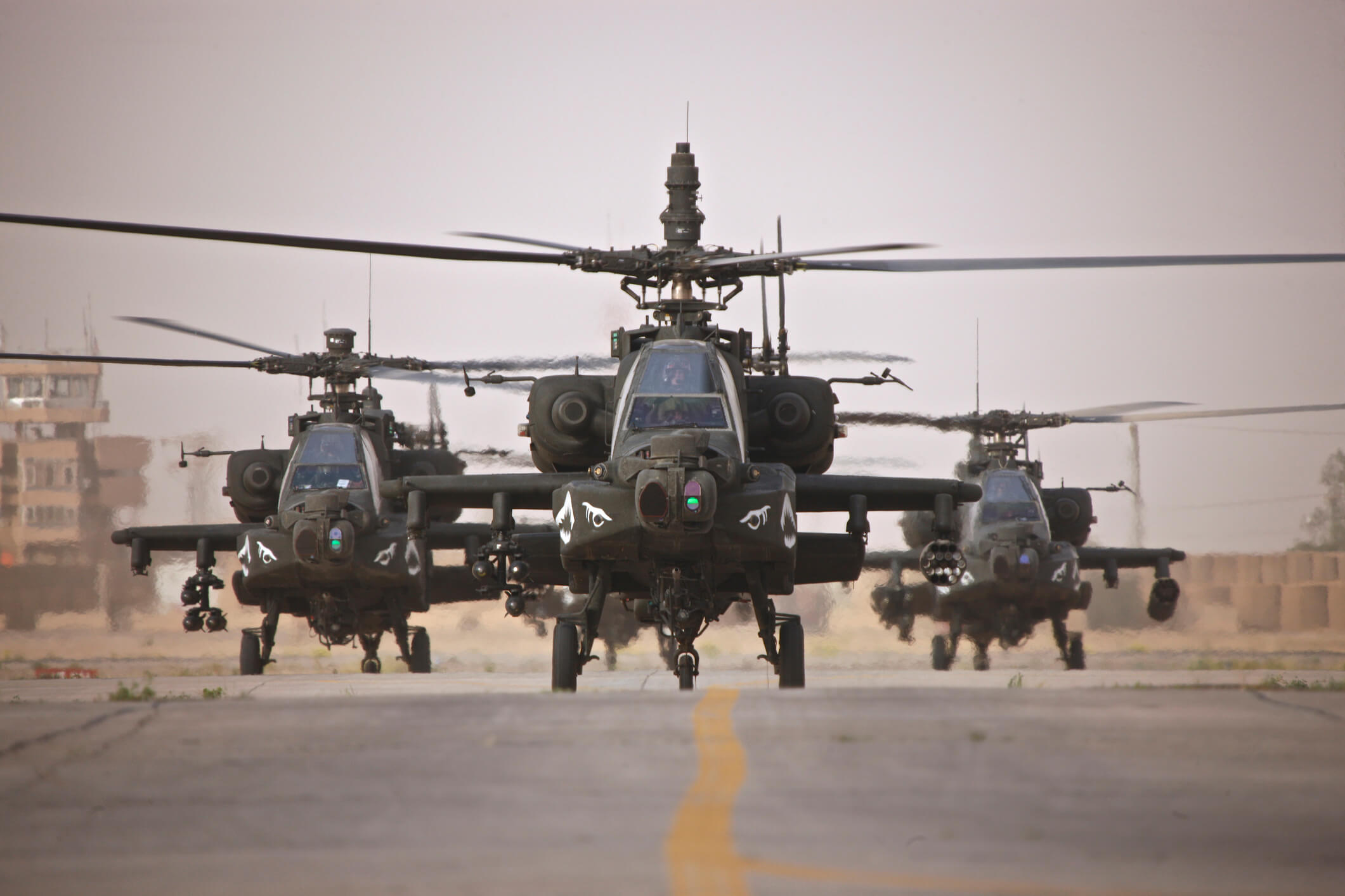 A Look at the Top Iraq War Helicopters - A group of AH-64D Apache helicopters on the runway at COB Speicher.