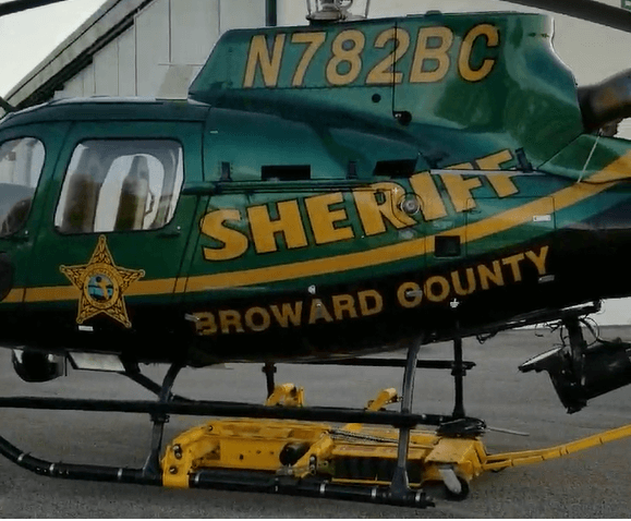 A green and gold helicopter marked 